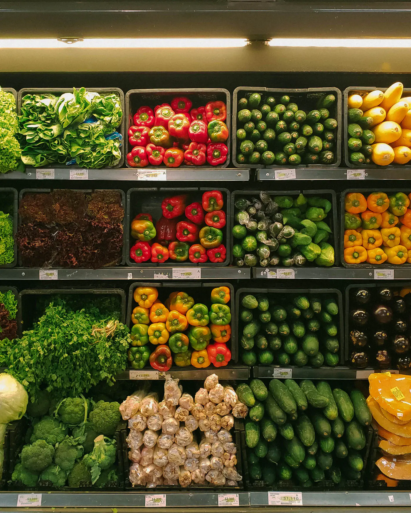 A well-stocked produce wall in a neighborhood grocery store